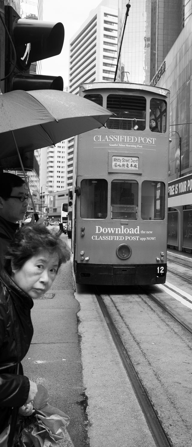 Woman waiting to cross tram line
