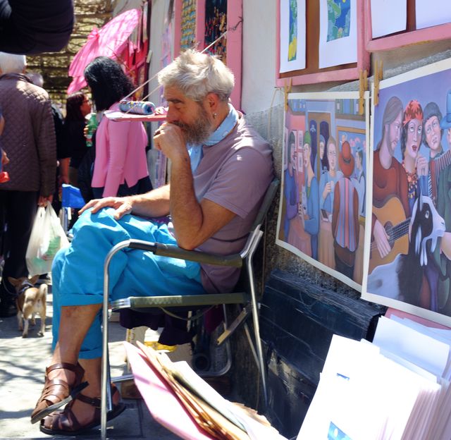 Sleeping artist at his stall on the street